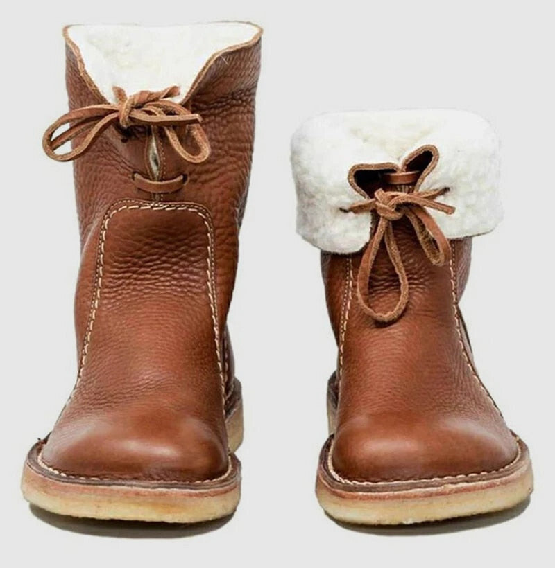 Women's brown shearling lined ankle boots with a flat grip sole