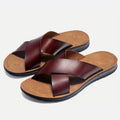 Dark brown crossover strap slides with tan footbed, pair product view