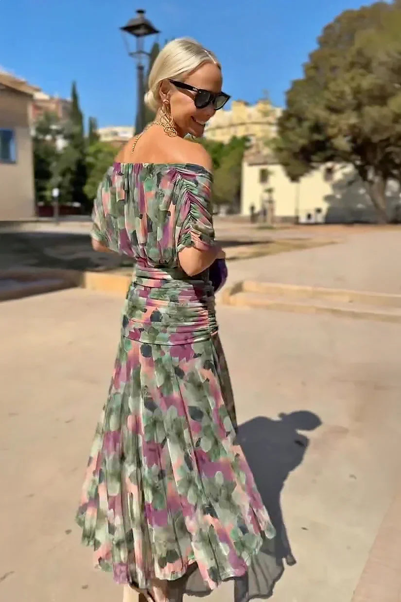 Woman wearing V-neck chiffon maxi dress, seated