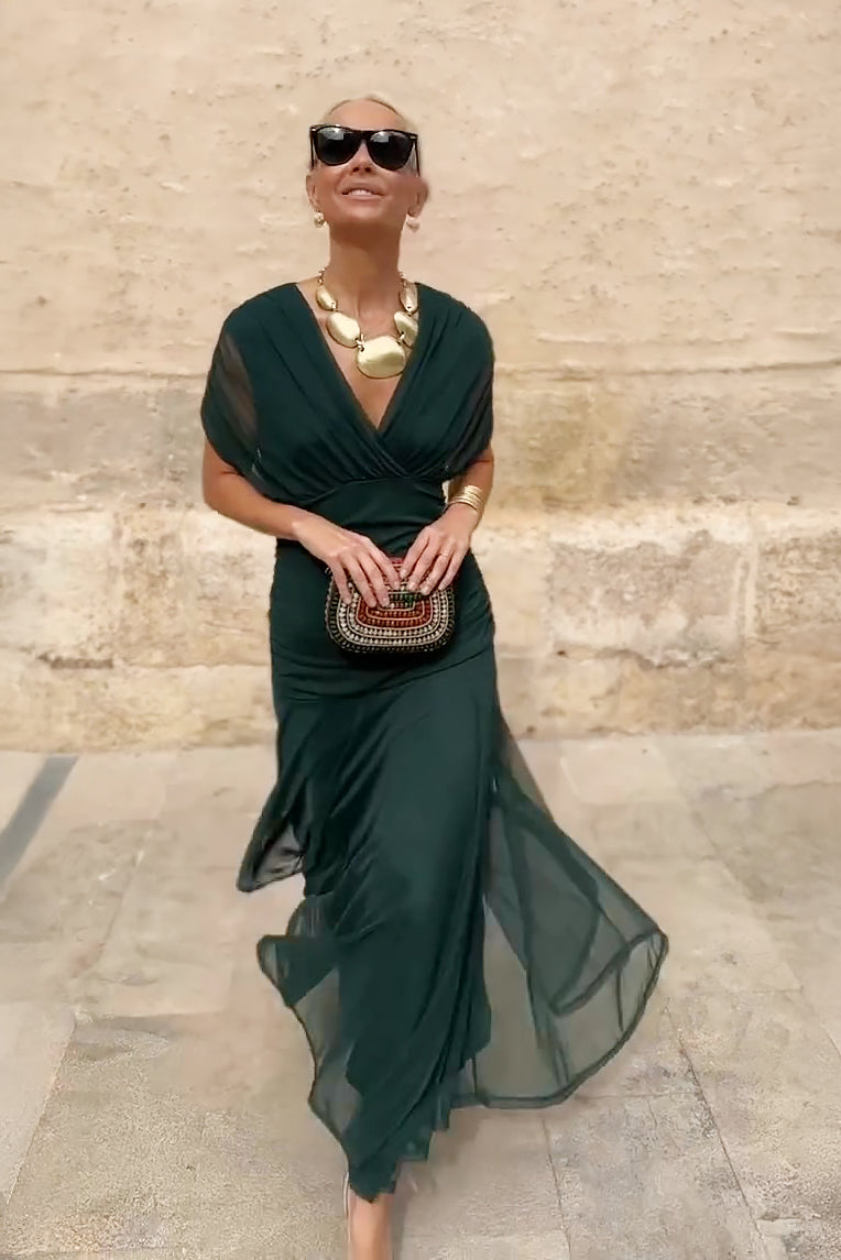 Bottle green chiffon maxi dress worn outdoors, full length