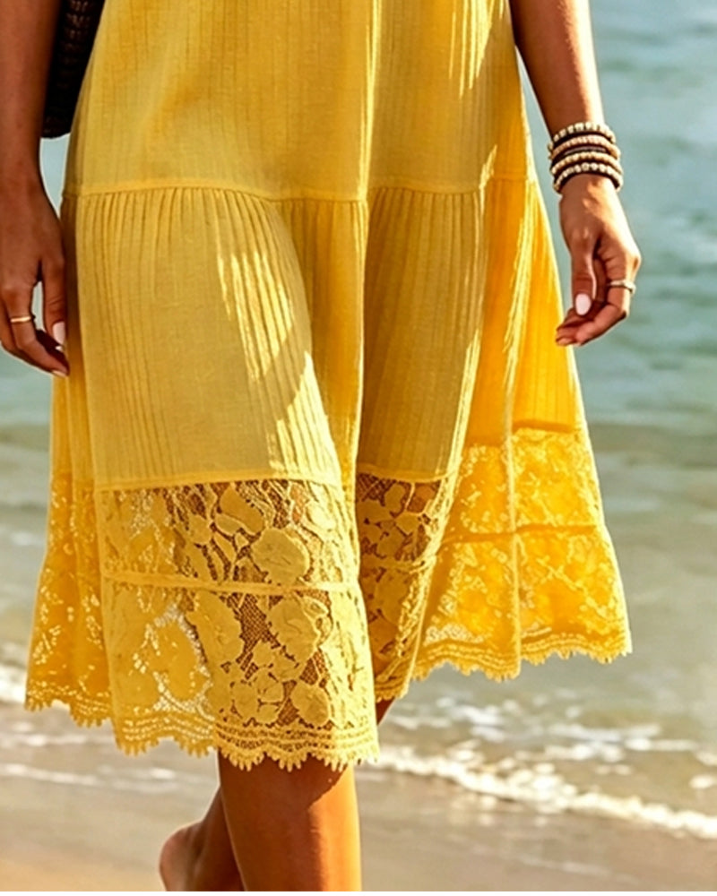 Yellow relaxed fit midi dress seen from the side in daylight