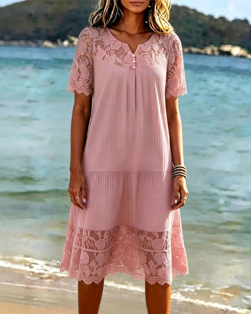 Pink midi dress showing the openwork lace yoke and button neckline