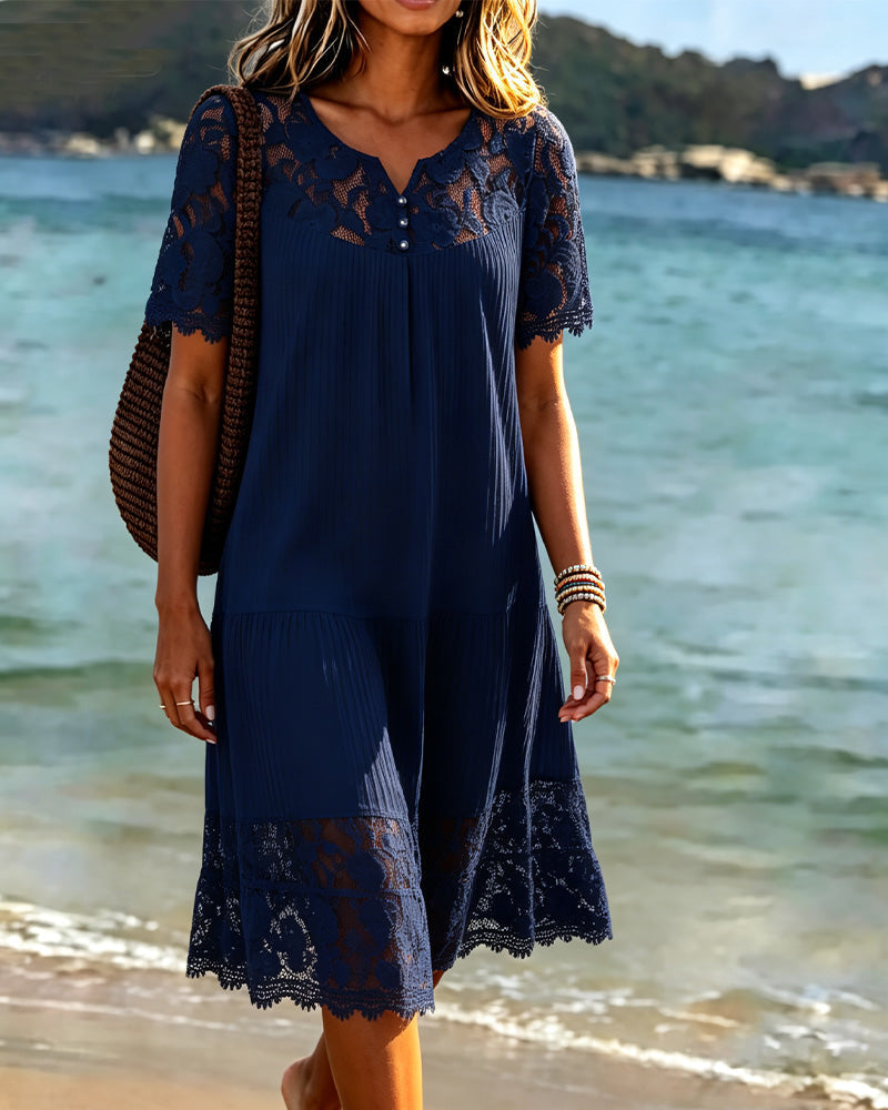 Navy lace trim tiered midi dress with short sleeves, worn on a beach