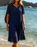 Navy lace trim tiered midi dress with short sleeves, worn on a beach