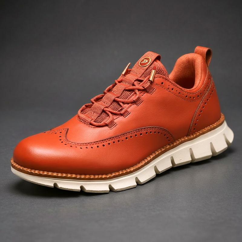 Terracotta wingtip brogue trainer with white flexible sole, side view