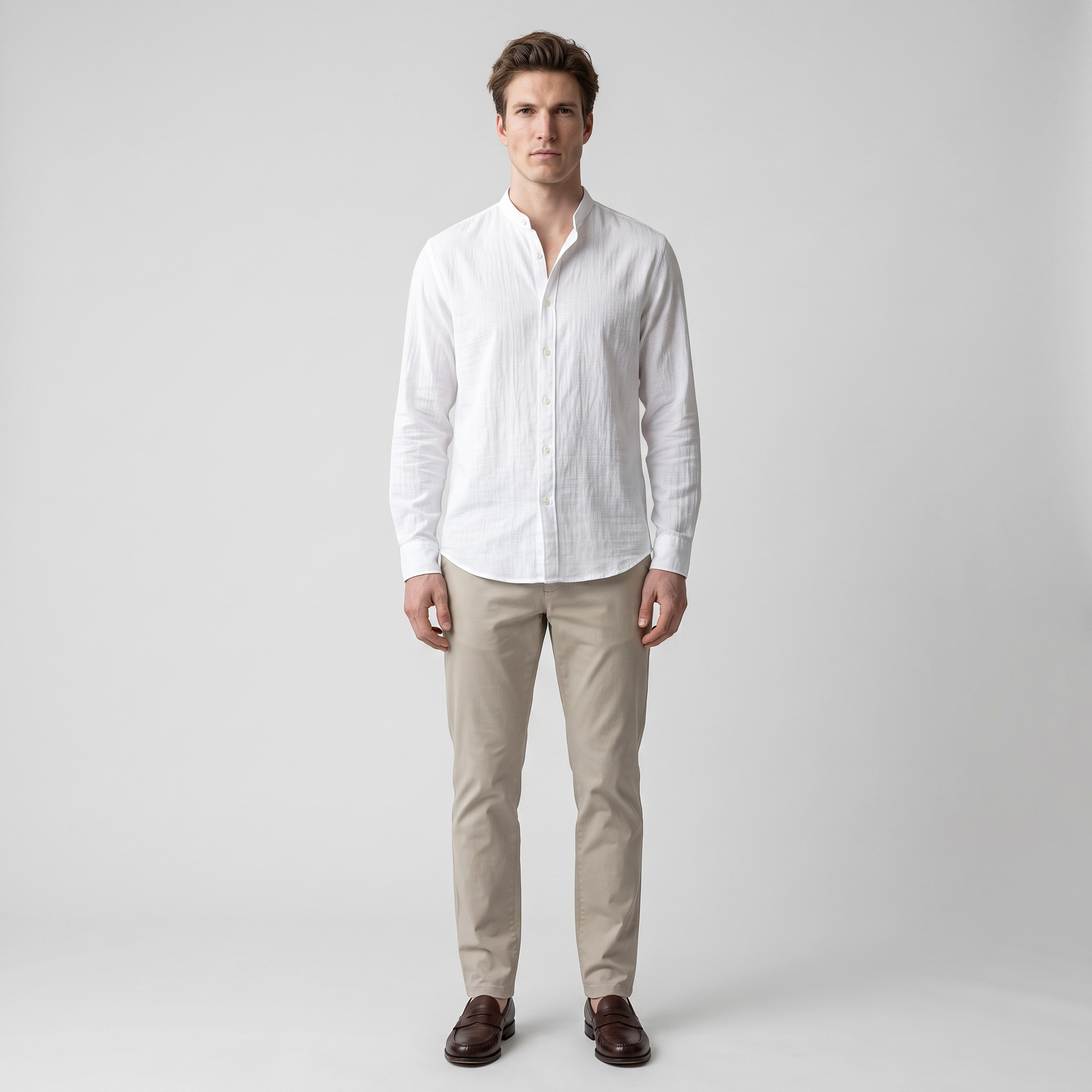Man wearing a white crinkle cotton band collar shirt with stone chinos