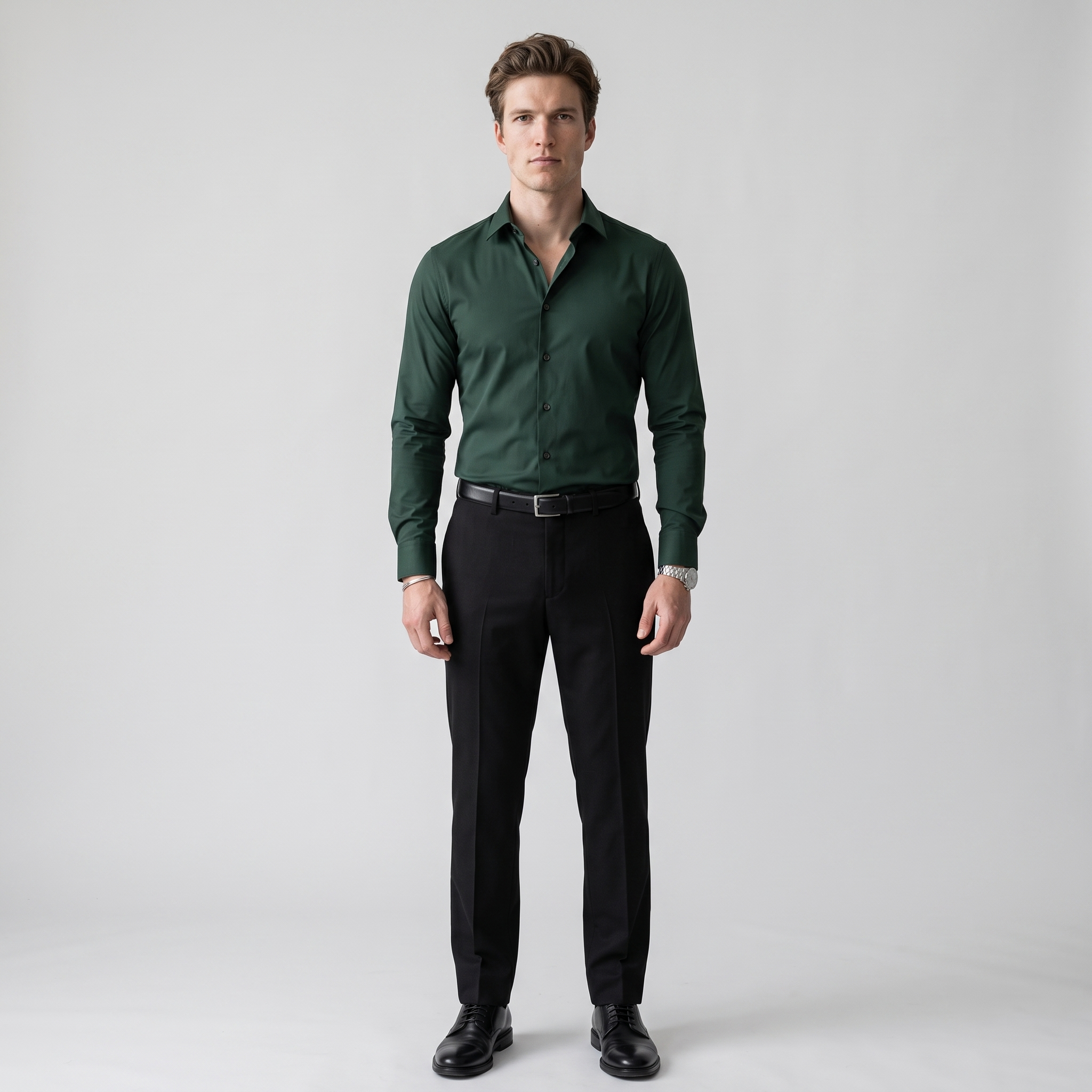 Man wearing a dark green slim fit long sleeve shirt with black wool trousers