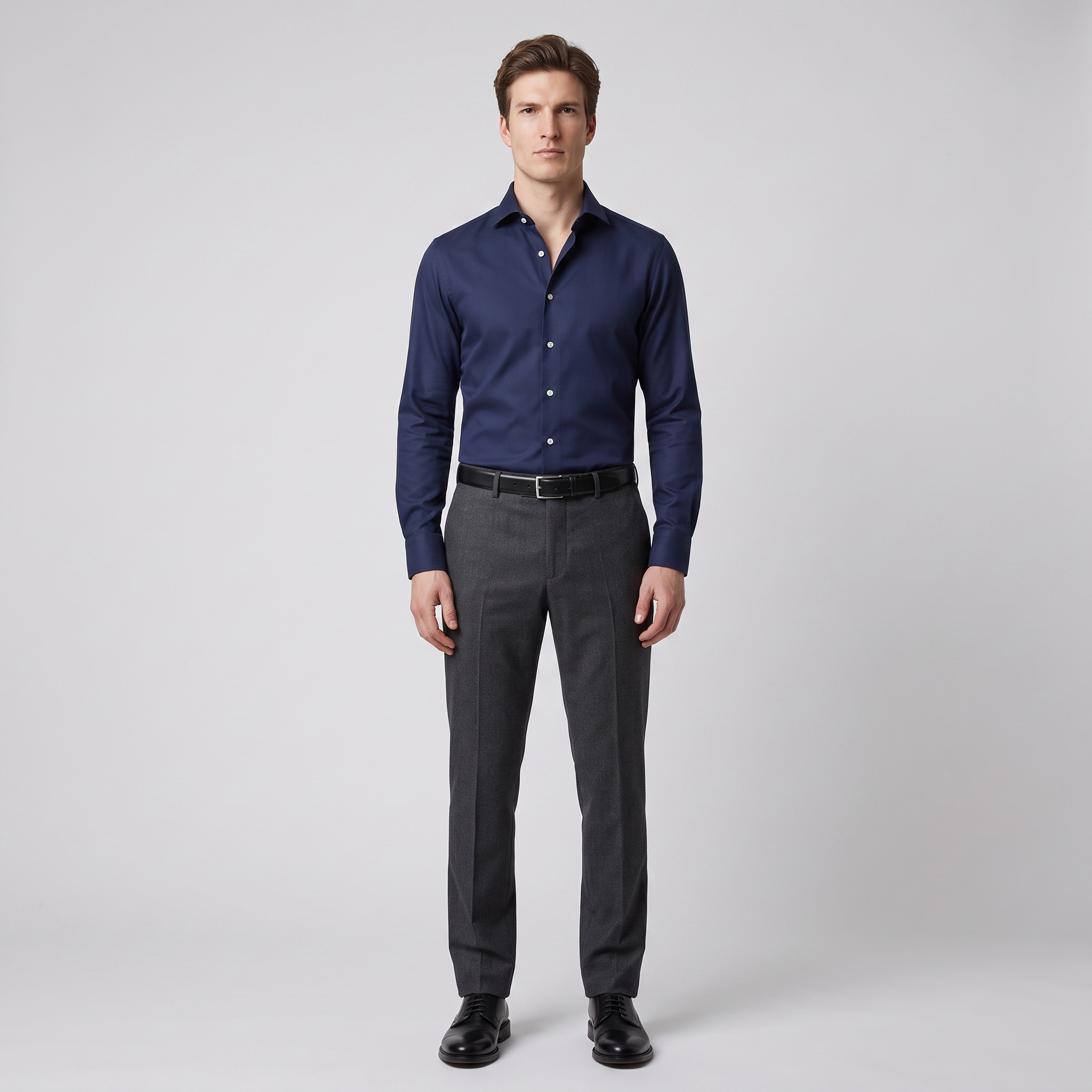 Man wearing a navy slim fit formal shirt in cotton twill with contrast white buttons