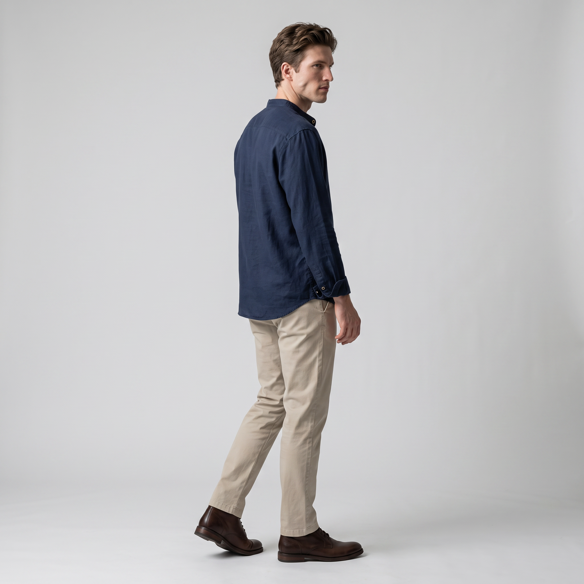 Side view of a navy popover shirt showing the curved back hem