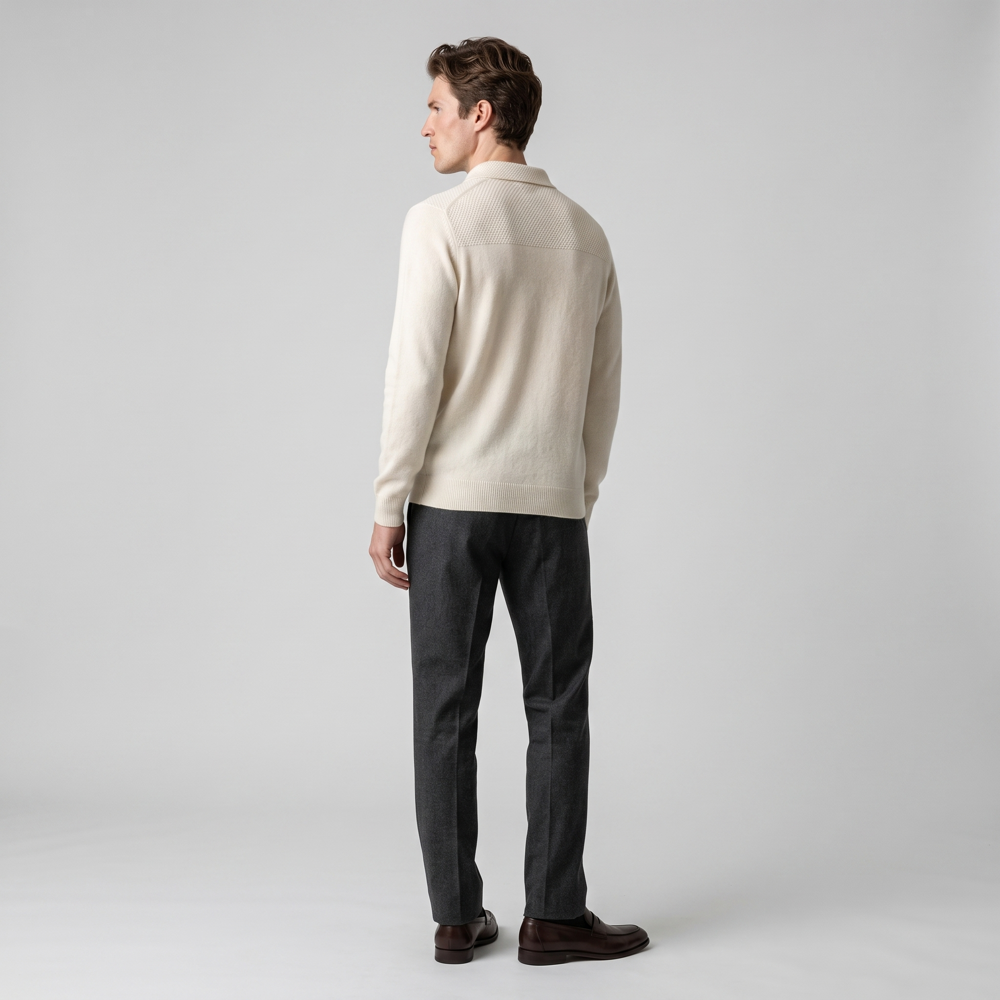 Side view of a cream knitted polo jumper showing the textured back yoke
