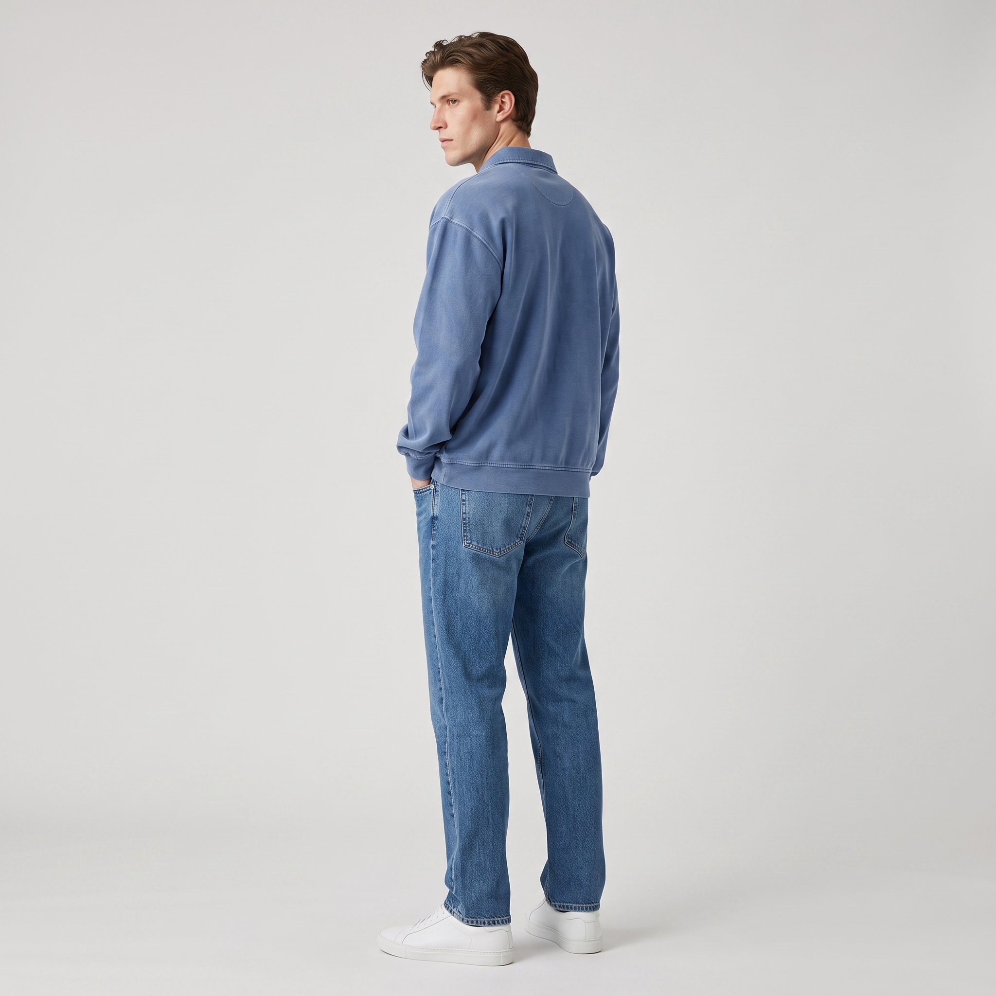 Side view of an oversized washed cotton polo sweatshirt with straight jeans