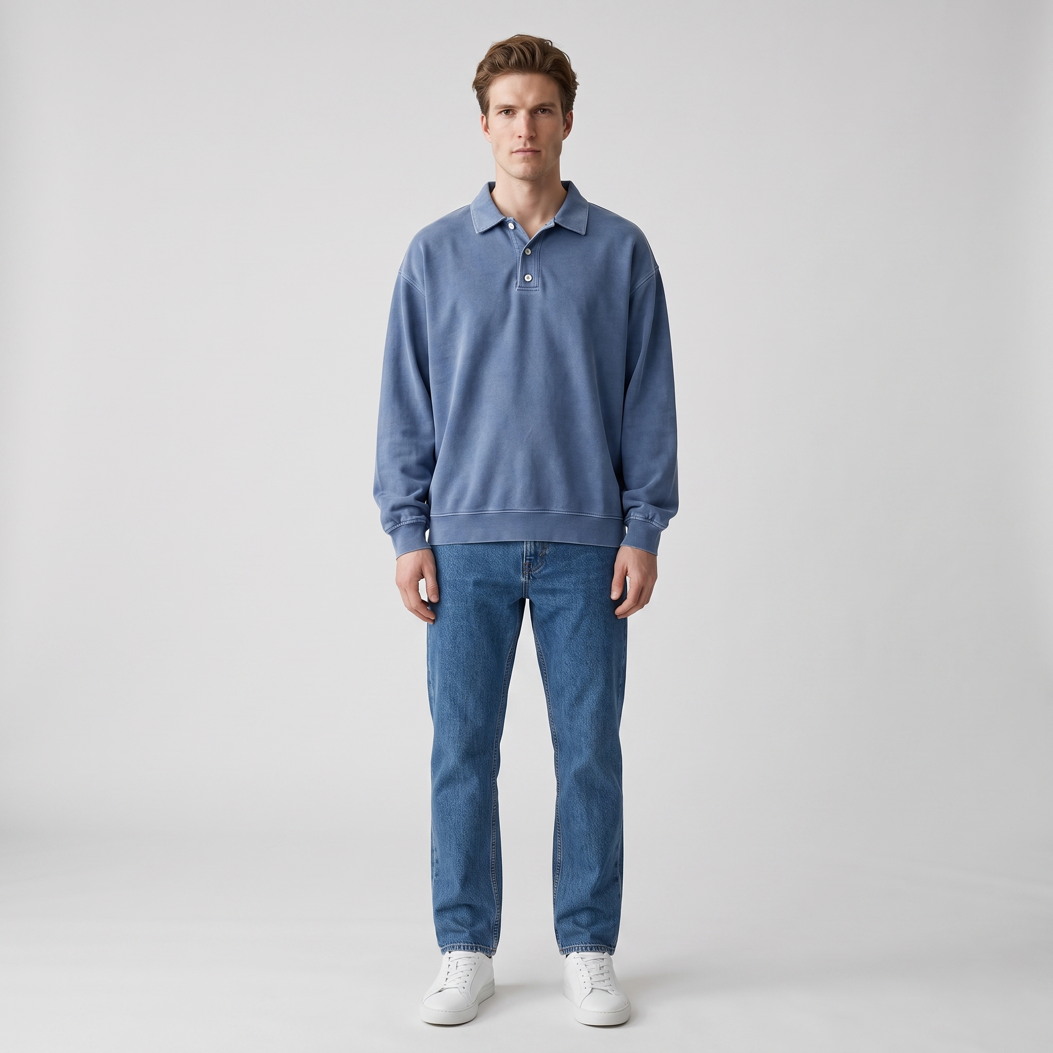Man wearing a dusty blue washed cotton polo sweatshirt with dropped shoulders