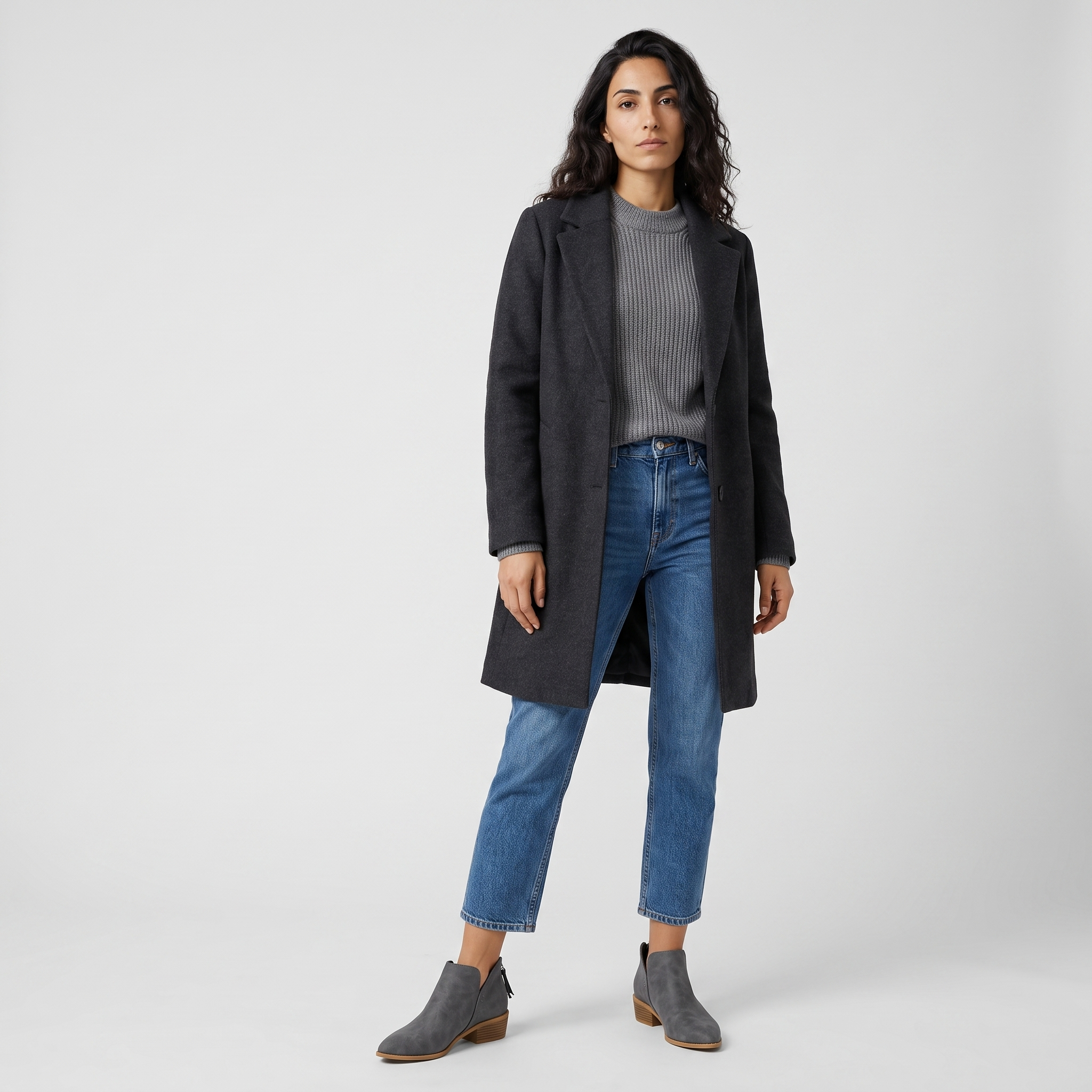 Woman wearing grey cut out ankle boots with cropped jeans and a charcoal coat