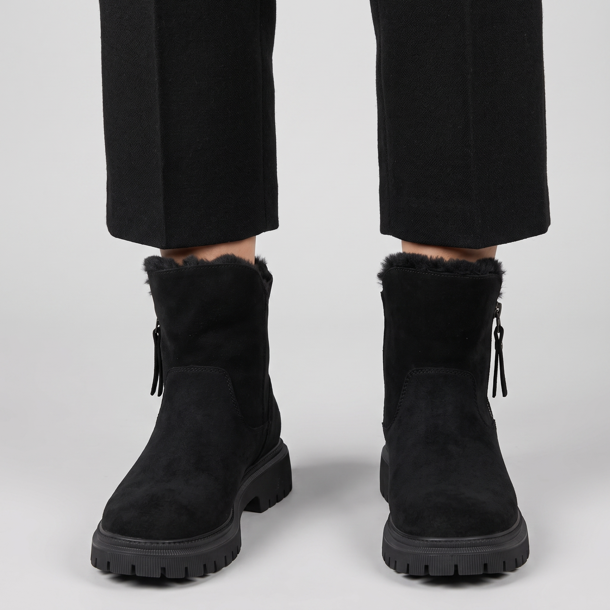 Women's black faux fur lined winter ankle boots with a chunky lug sole