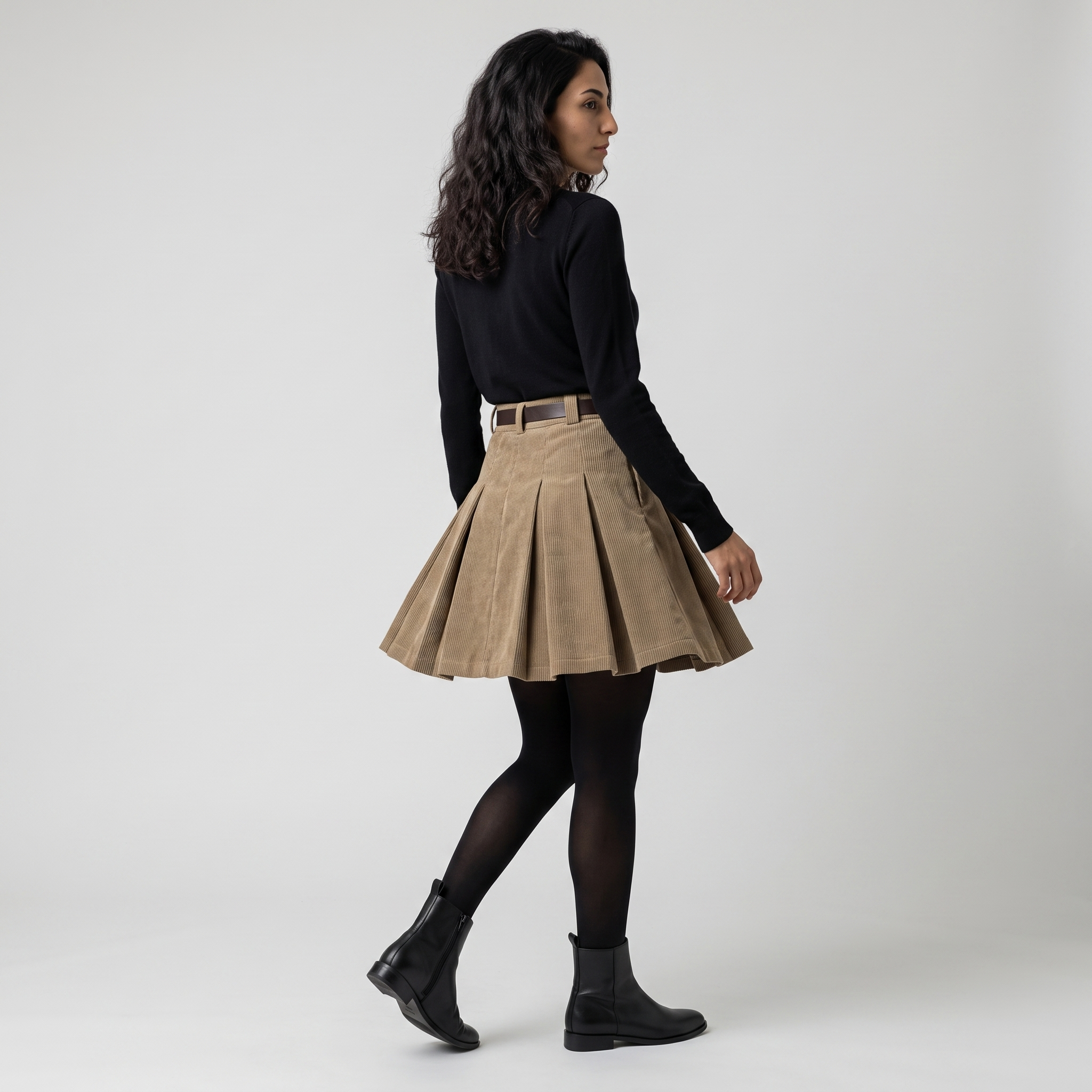 Side view of a pleated corduroy mini skirt showing the box pleats