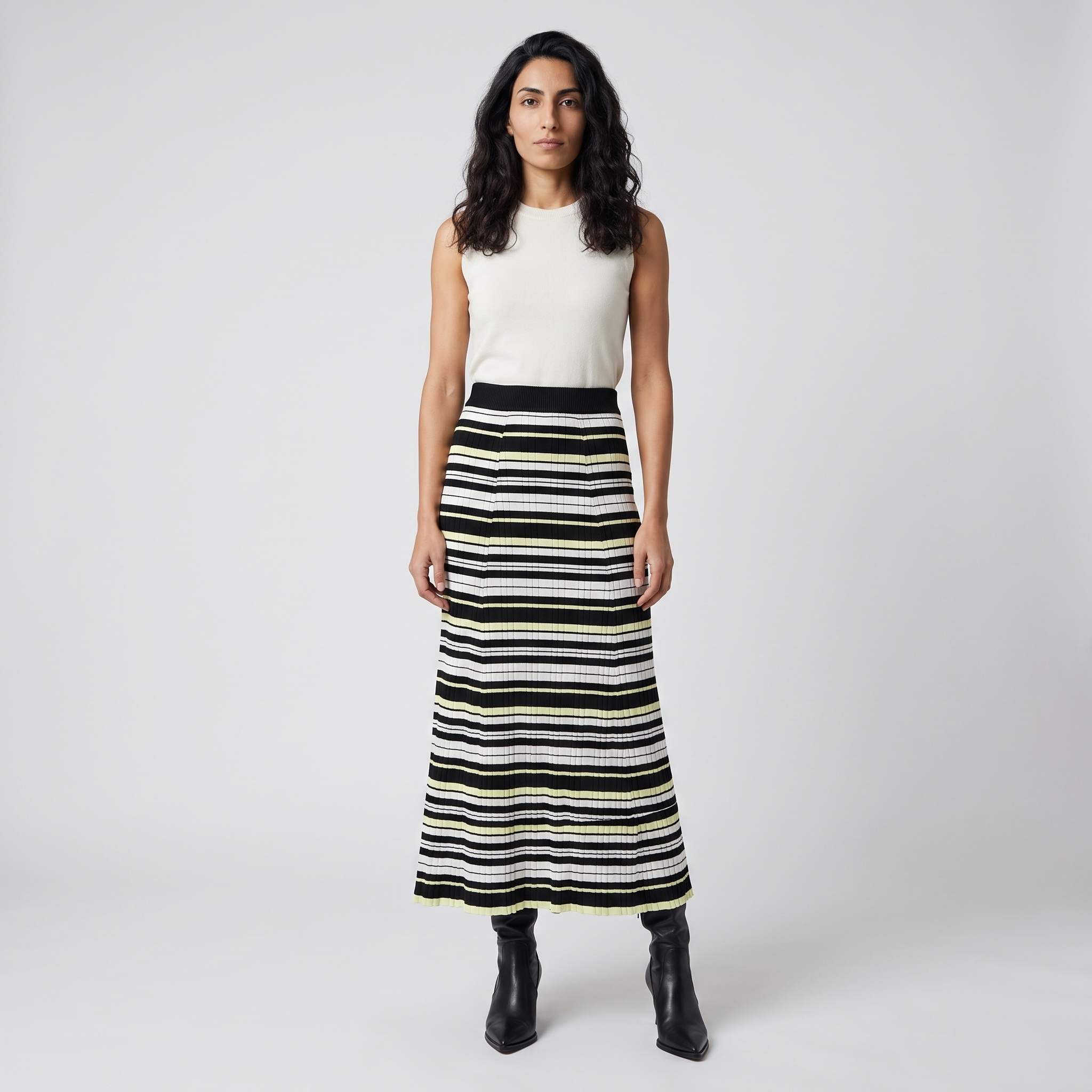 Woman wearing a black ivory and yellow striped knit midi skirt