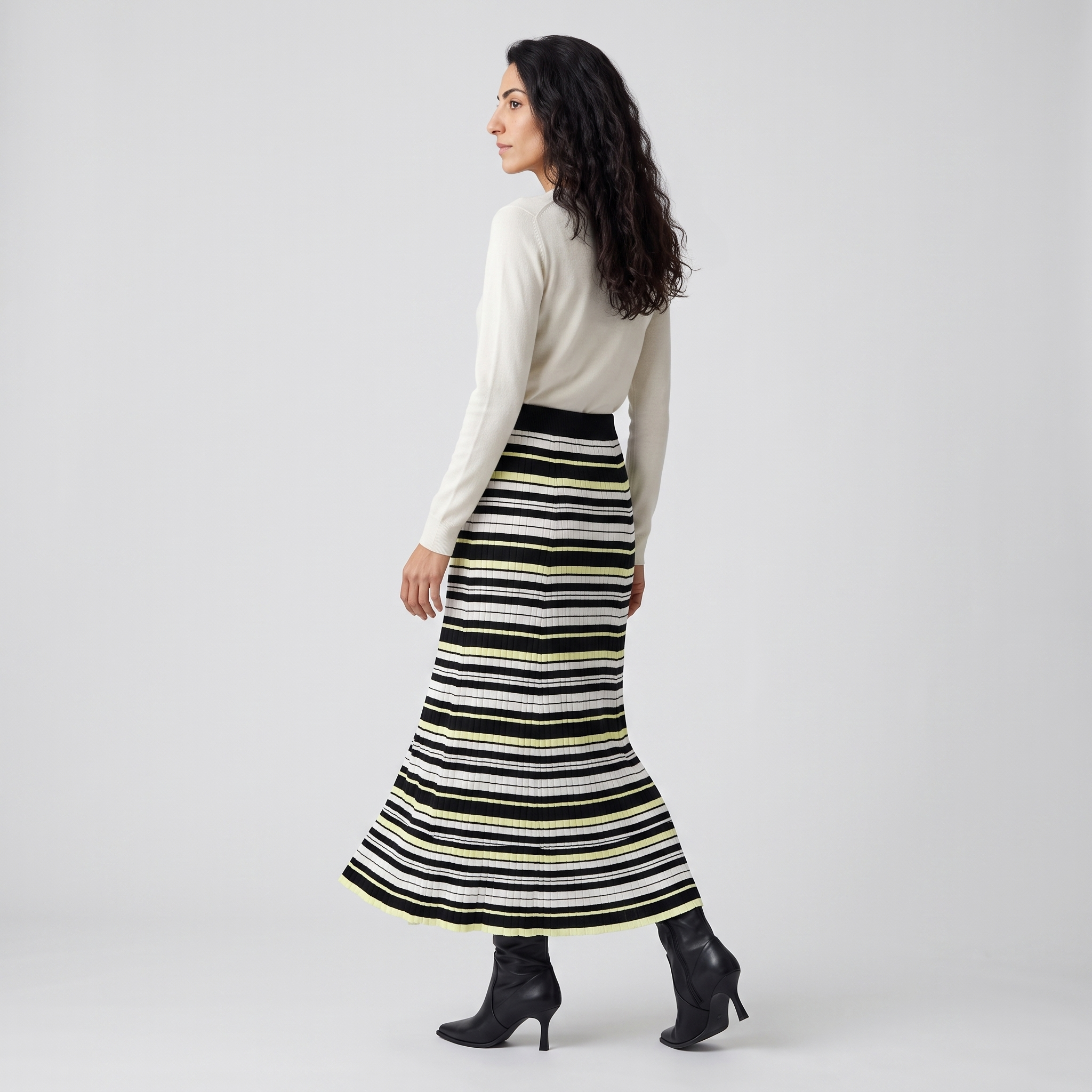 Side view of a striped rib knit midi skirt showing the gentle flare