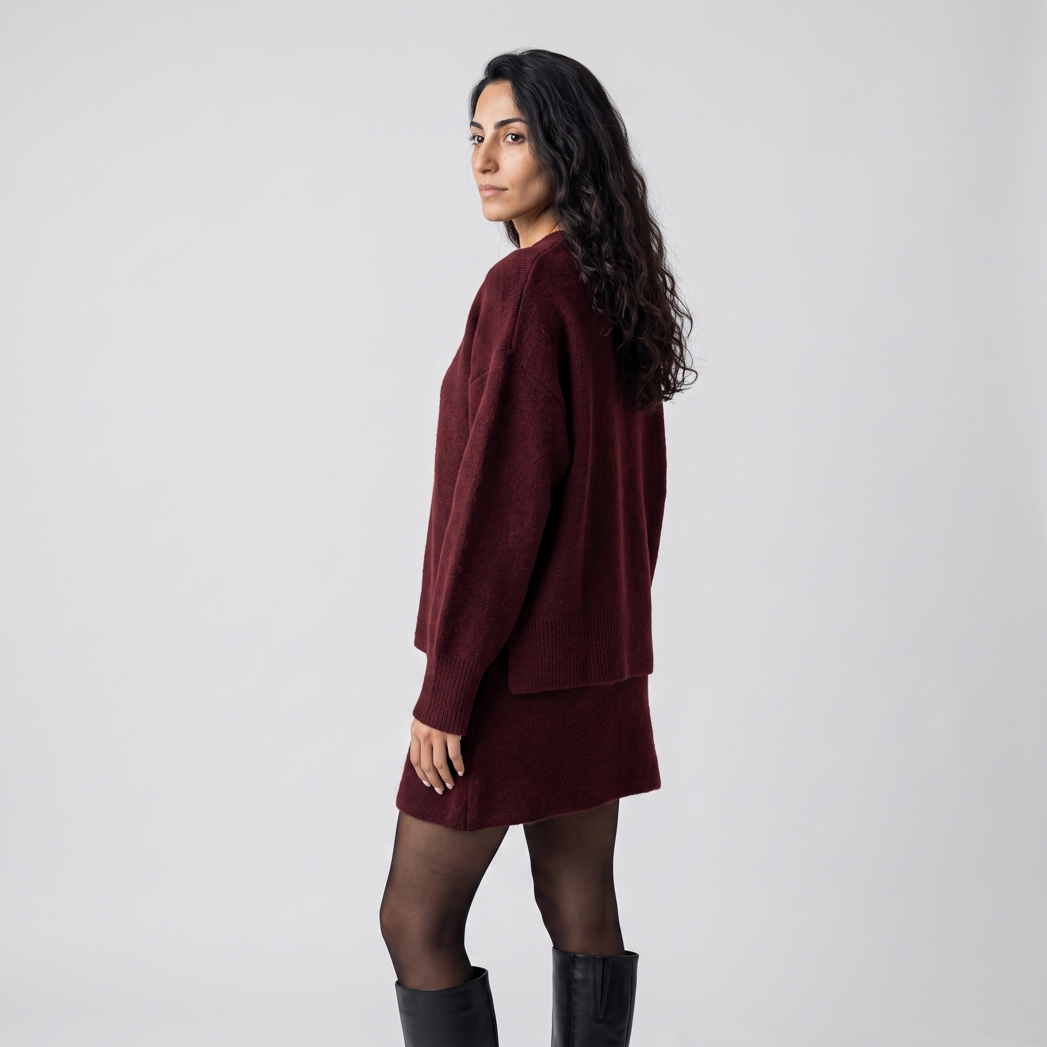 Side view of a wine red knitted two piece set with an oversized jumper