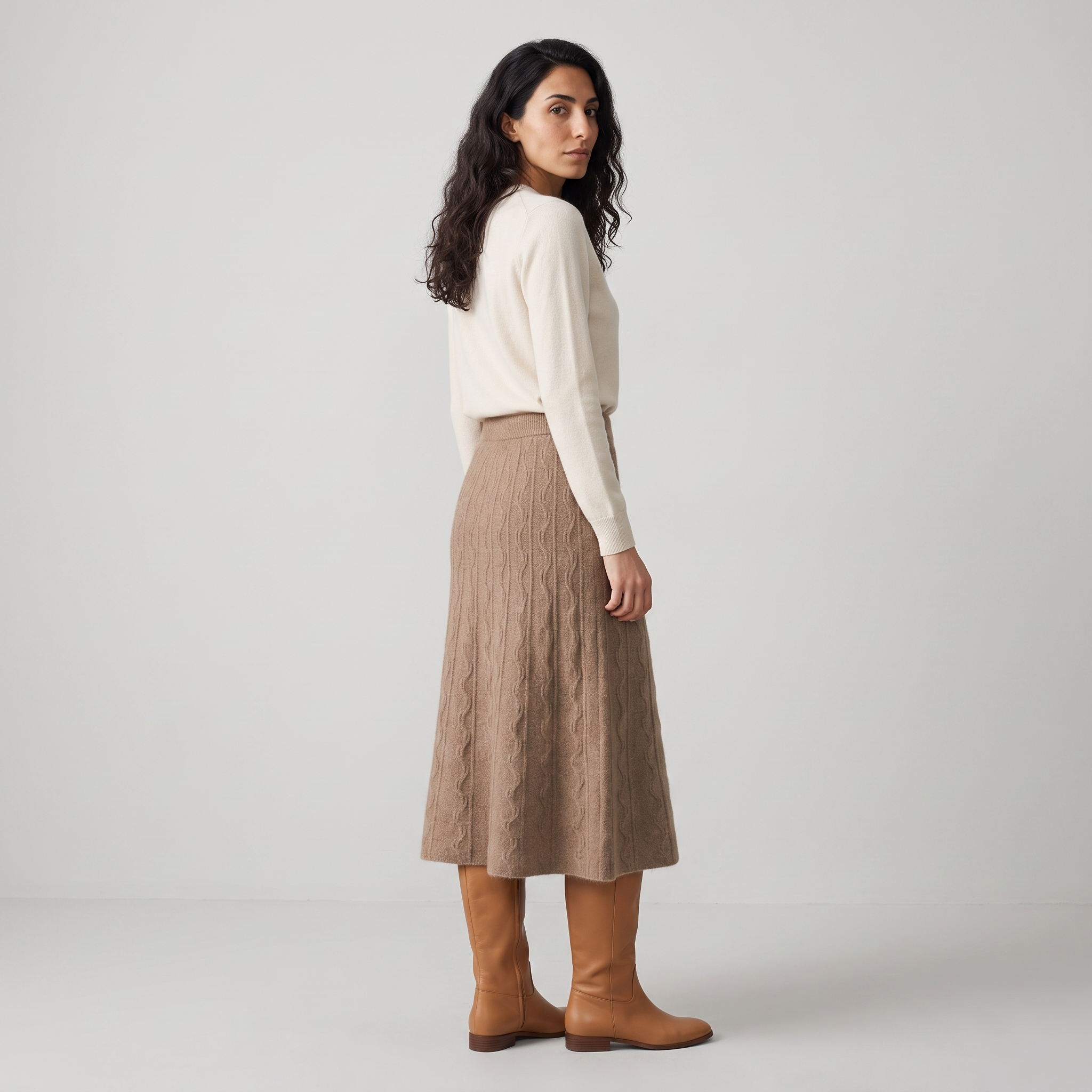 Side view of a camel cable knit midi skirt in a brushed yarn