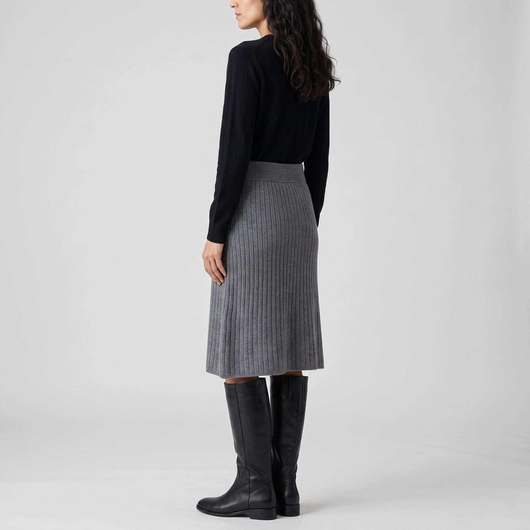 Side view of a grey rib knit skirt with a wide ribbed waistband