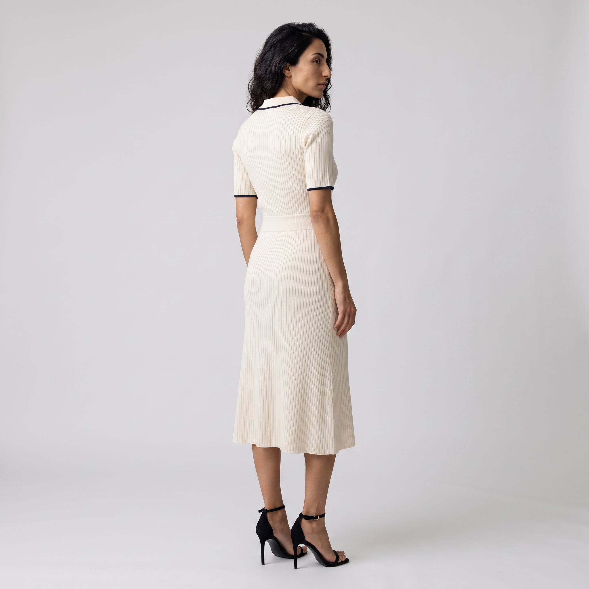 Side view of a cream rib knit polo dress falling to mid-calf