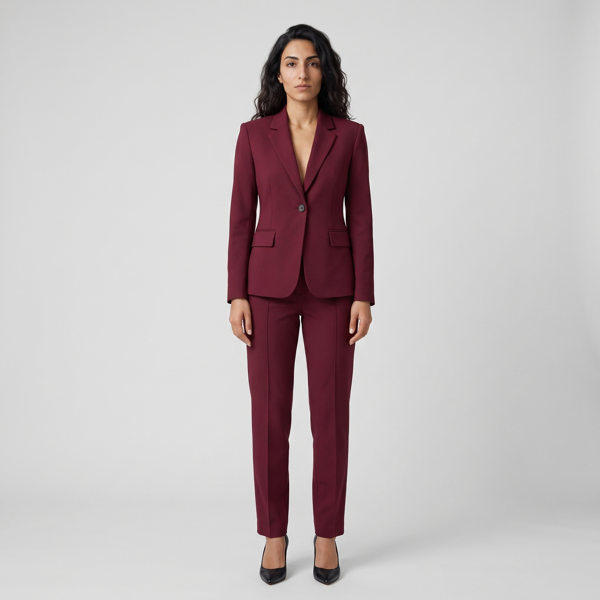 Woman wearing a wine red single button tailored blazer with matching trousers