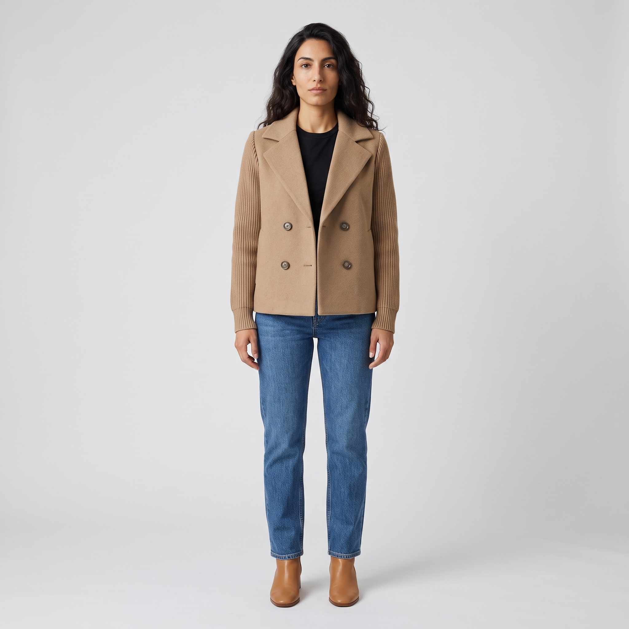 Woman wearing a camel double breasted blazer with ribbed knit sleeves