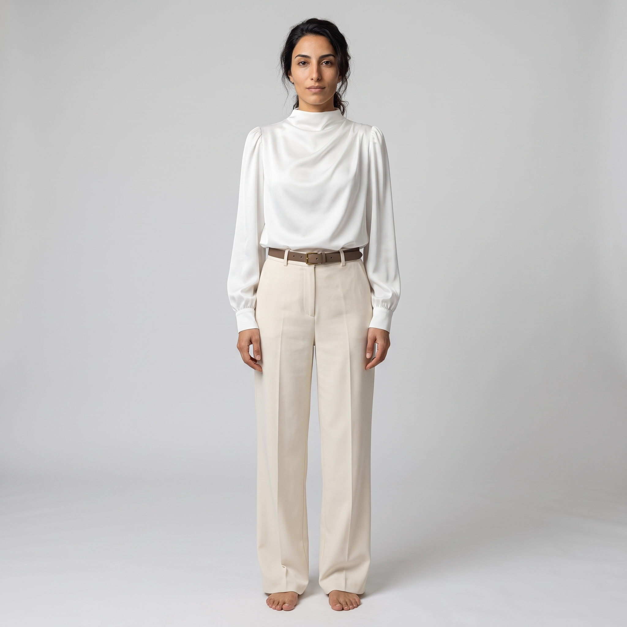 Woman wearing a white satin funnel neck blouse with puff shoulders