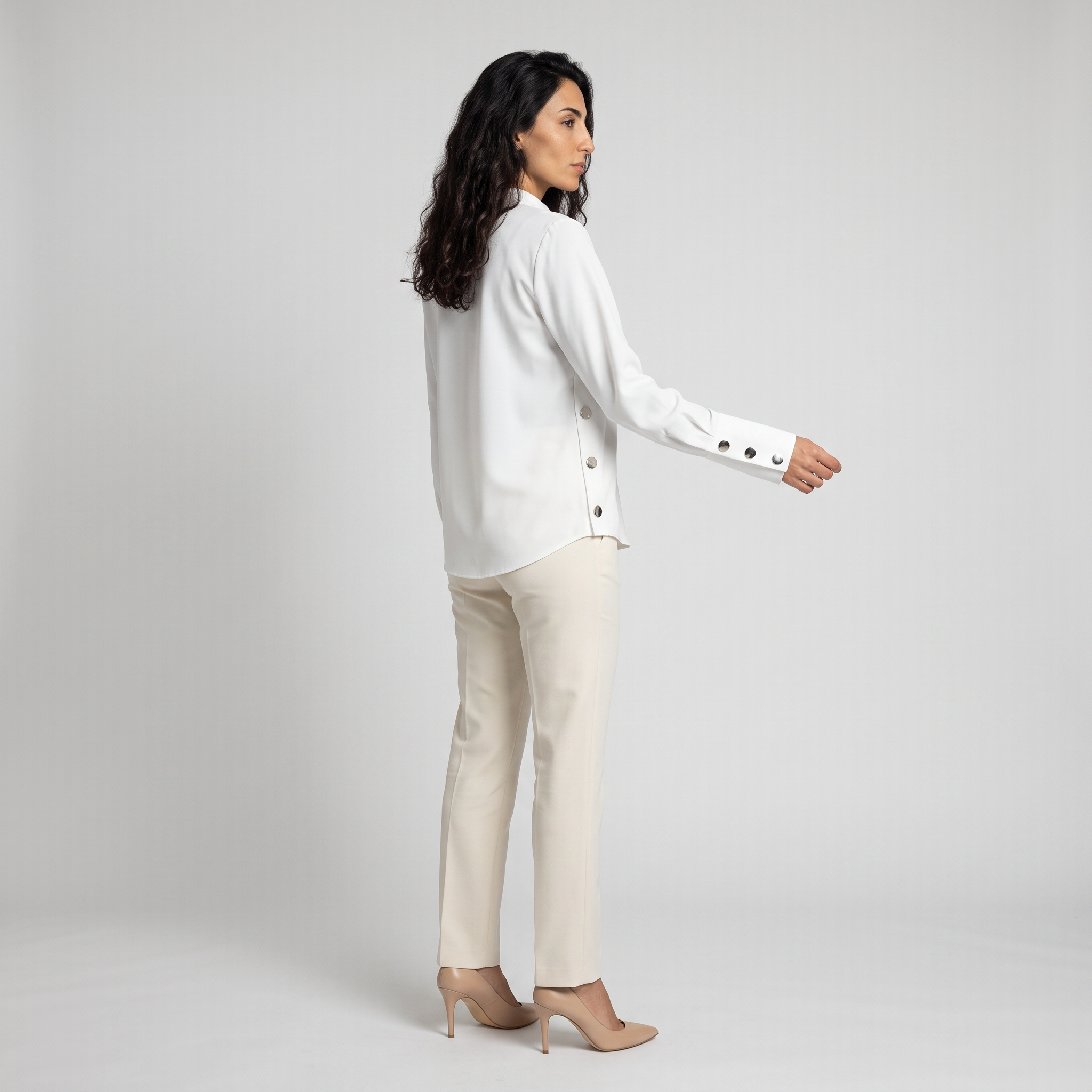 Side view of a white blouse showing the deep cuff with four metal buttons
