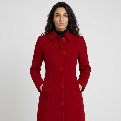 Model wearing deep red longline overcoat, front view, square buttons and fitted waist