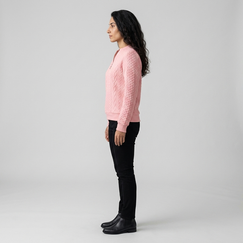 Side profile of pink cable knit jumper showing stand collar and ribbed hem