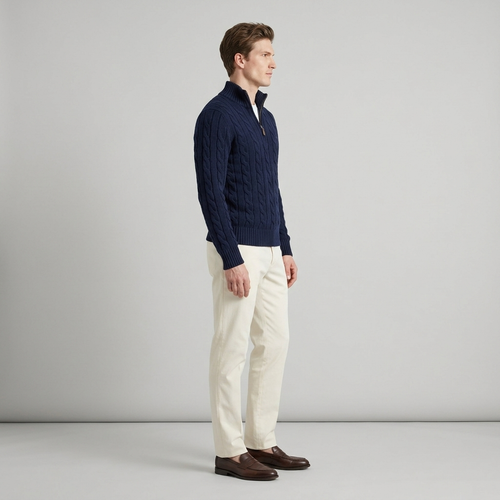Man wearing a navy cable knit half zip jumper, side view