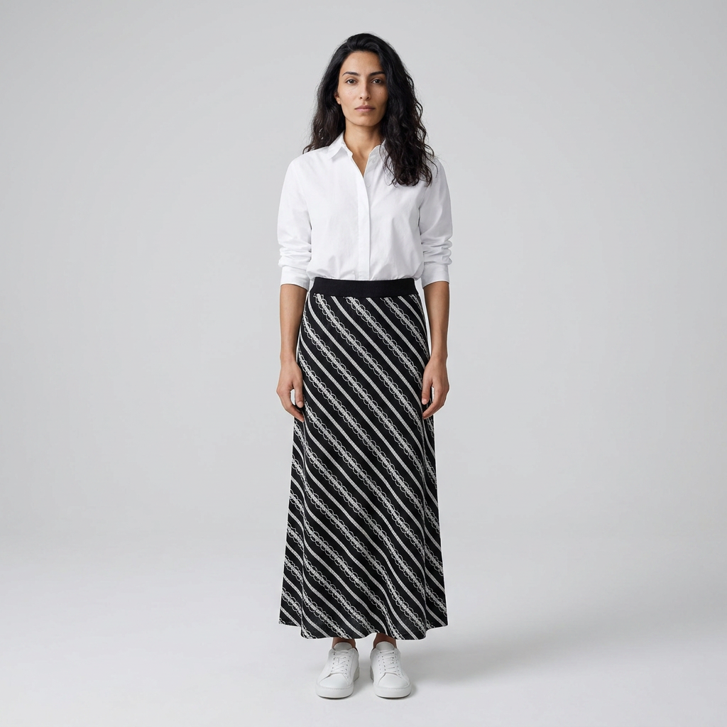 Model wearing black and white striped knitted maxi skirt, front view