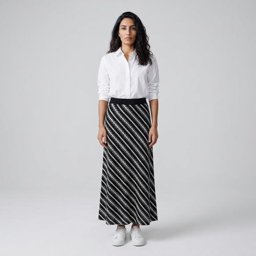 Model wearing black and white striped knitted maxi skirt, front view