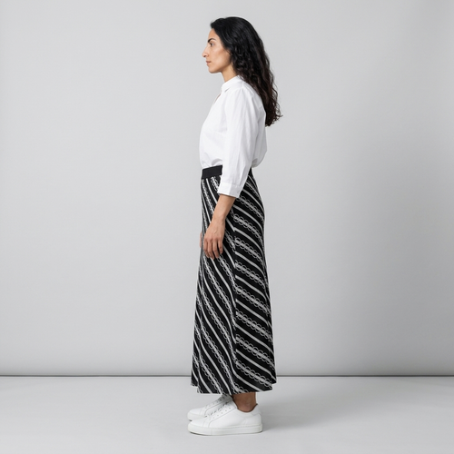 Side view of black and white diagonally striped maxi skirt