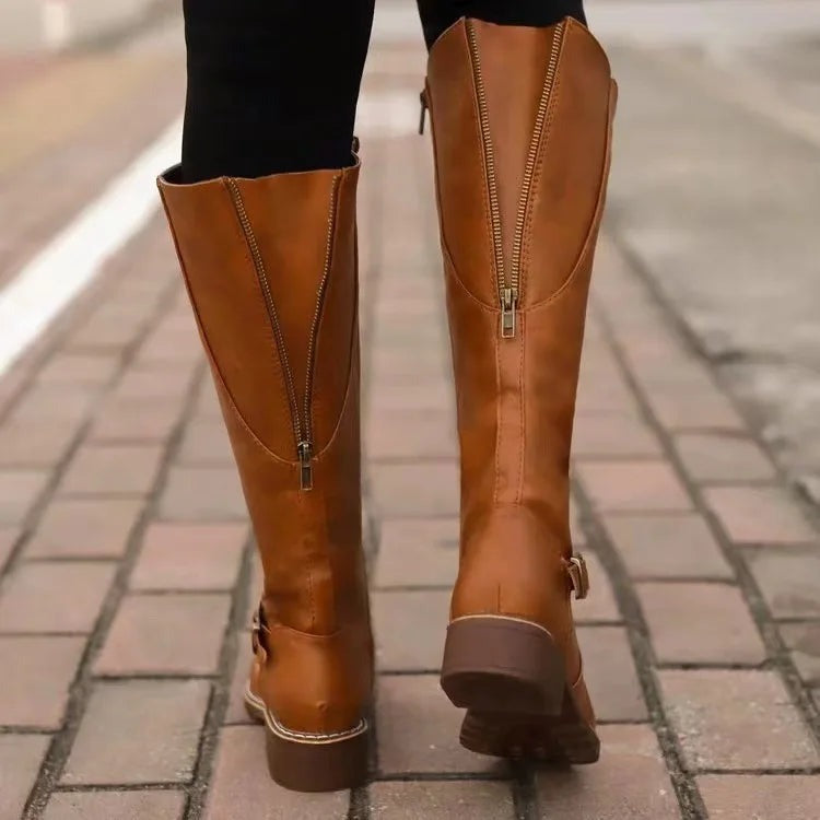 Detail of the leather look upper and stitching on knee high riding boots