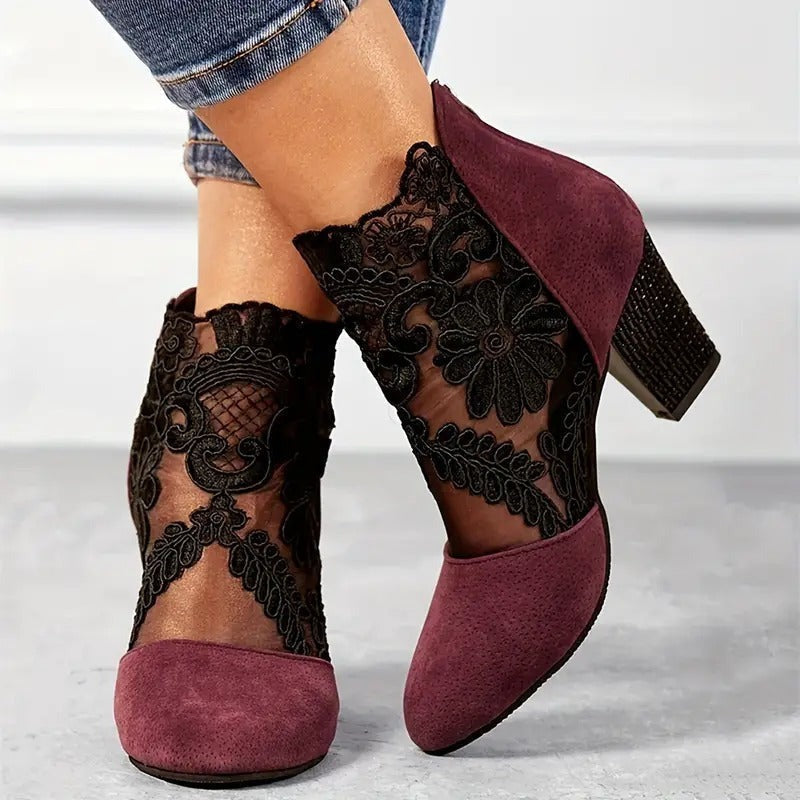 Side view of lace up ankle boots showing the block heel and eyelets