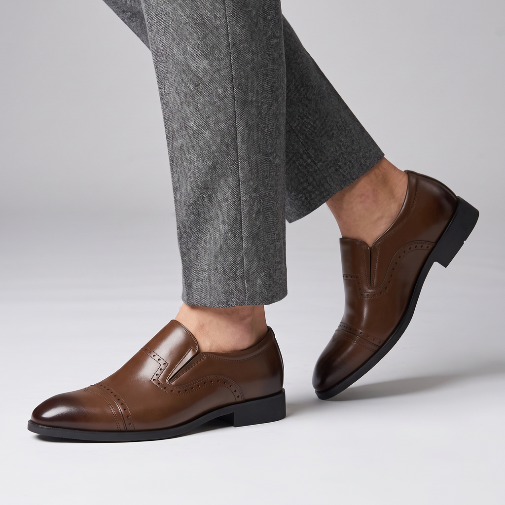 Model wearing the brown slip on brogue loafers with cap toe, studio shot