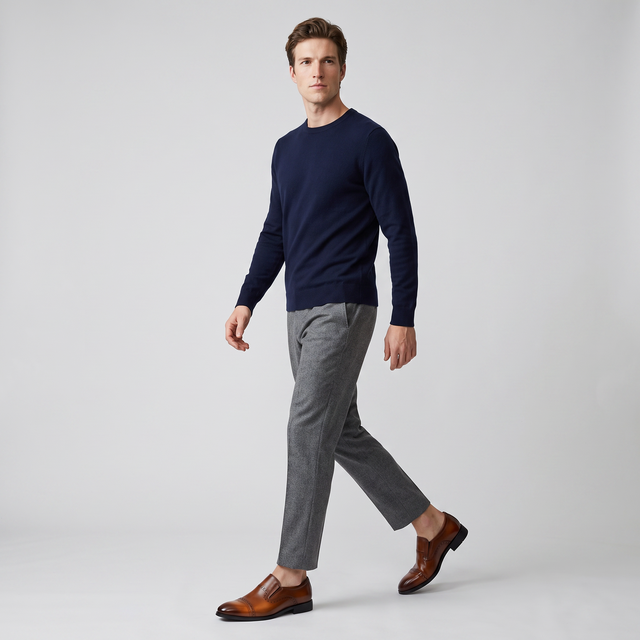 Full length studio shot of a model walking in the brown slip on brogue loafers
