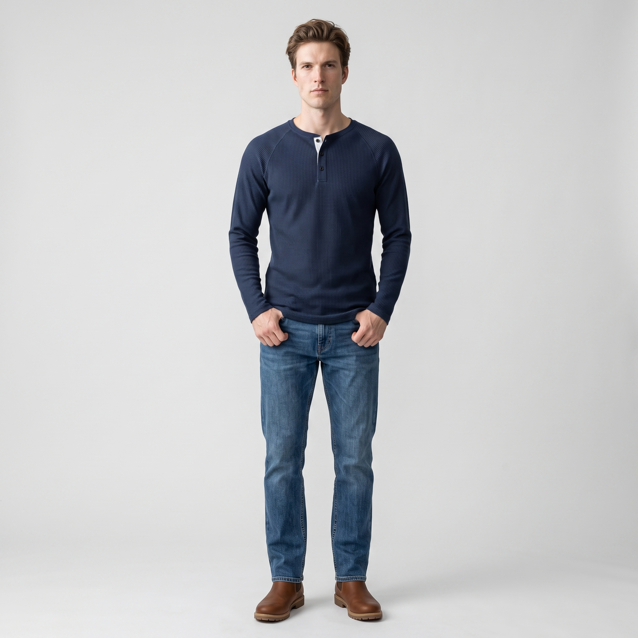 Model wearing the navy waffle knit henley with denim, studio shot