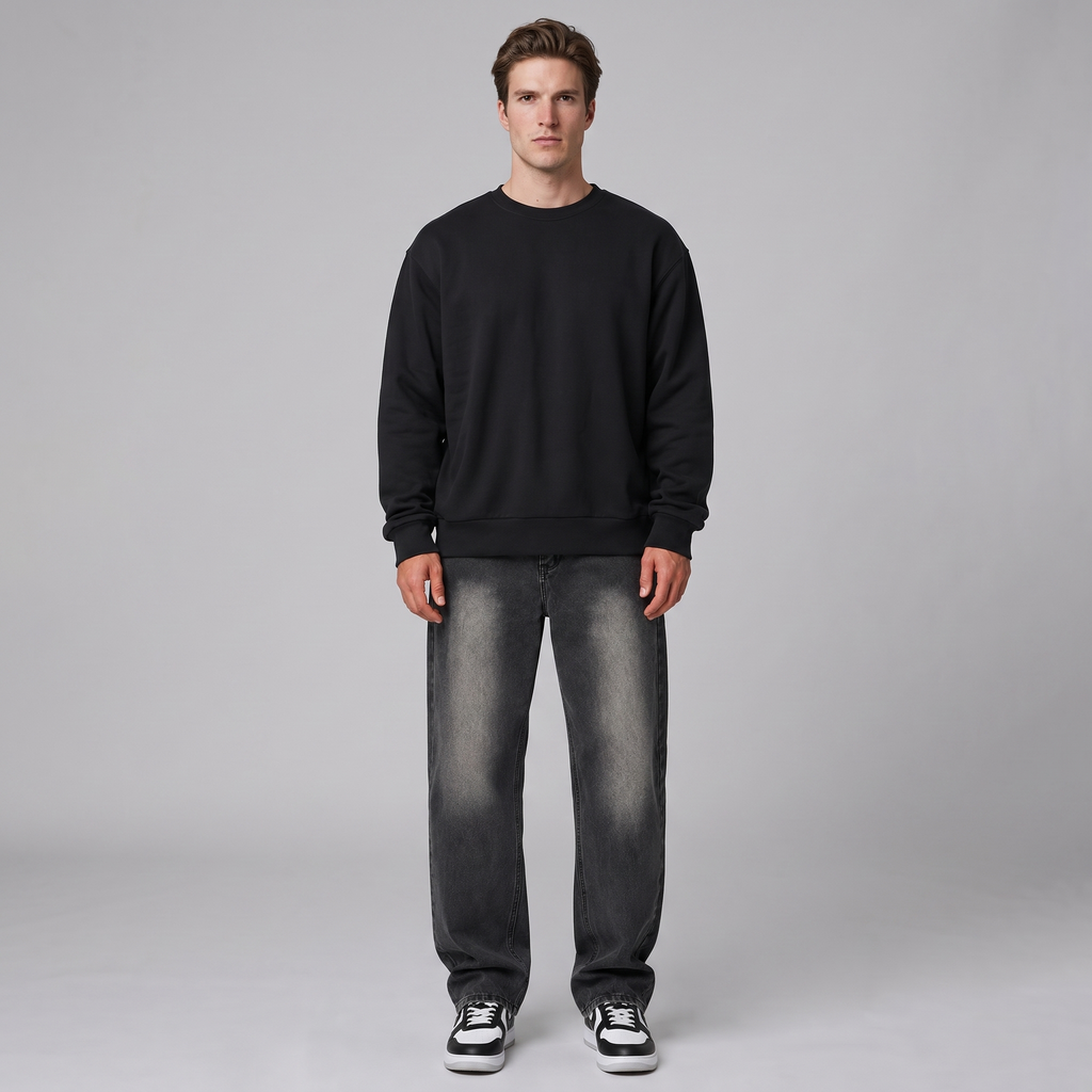 Model wearing the washed black relaxed straight leg jeans, studio shot