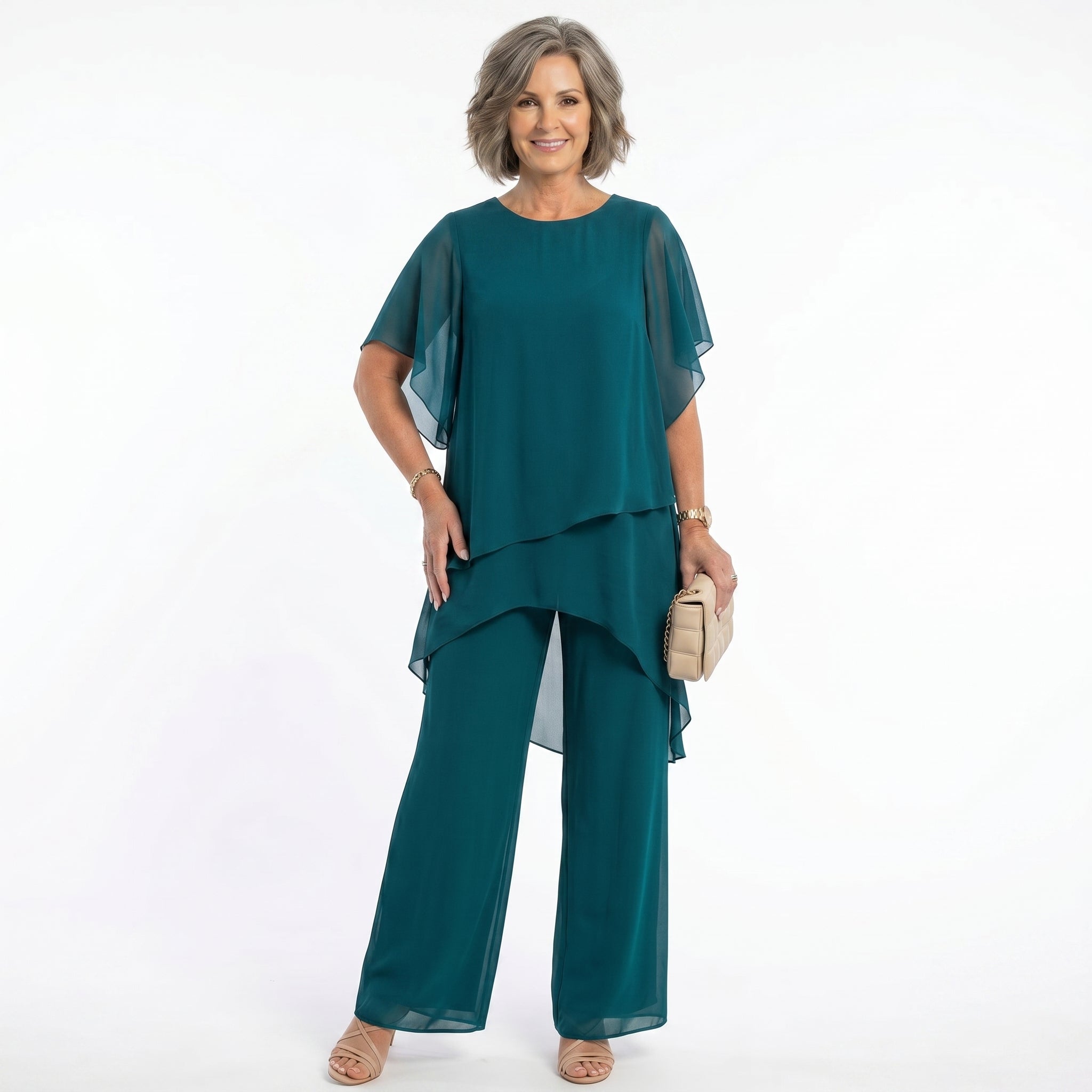Woman wearing navy chiffon tunic and trousers set, full length