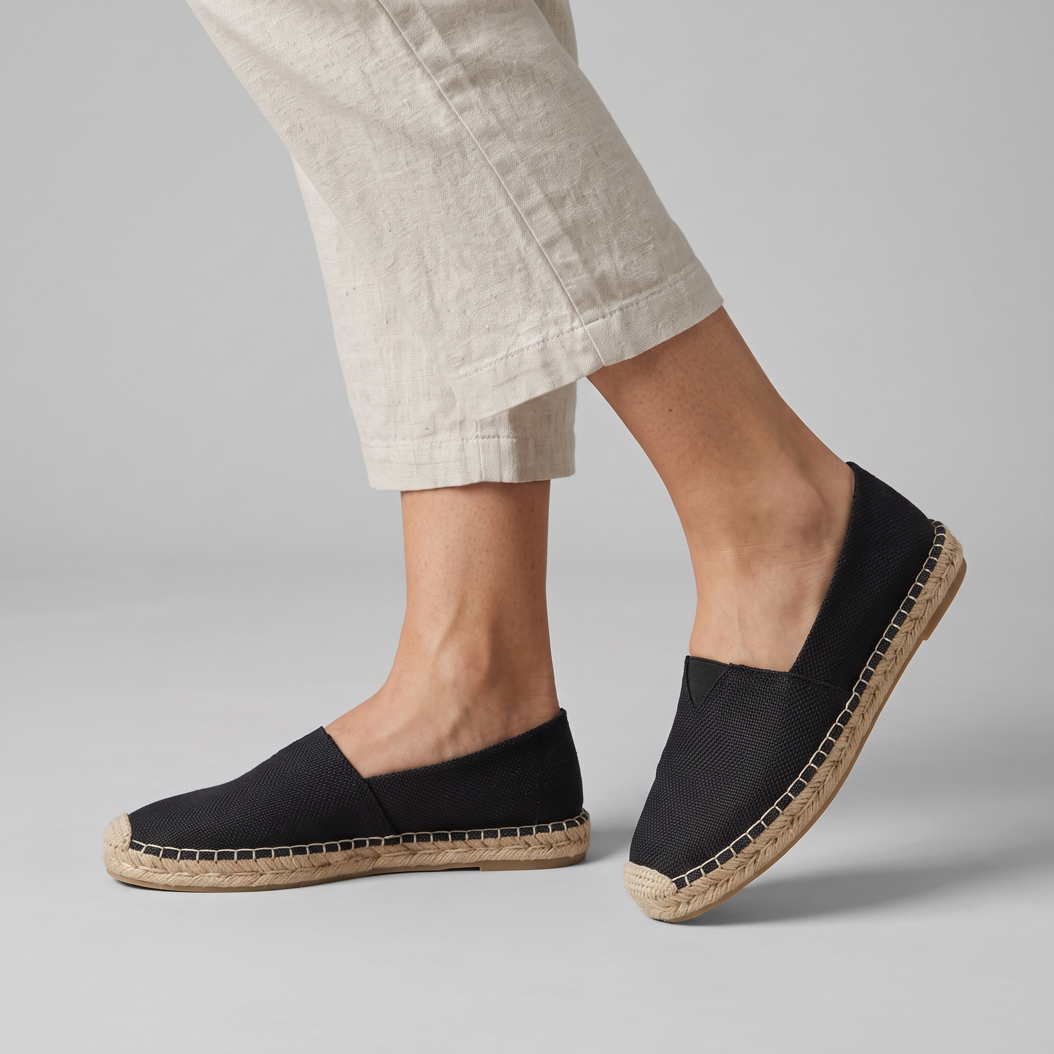Model wearing the black canvas espadrilles with natural jute sole, studio shot