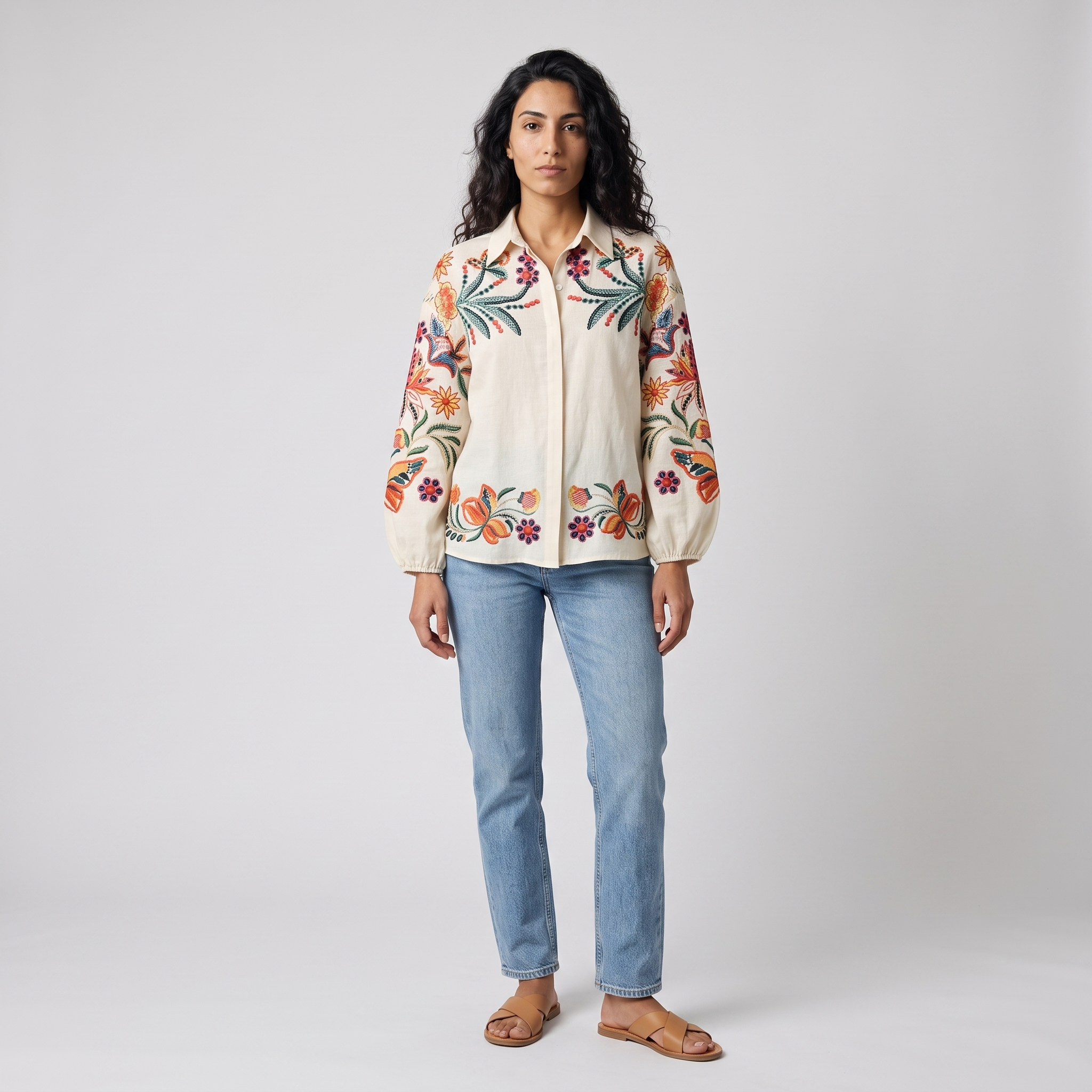 Model wearing the cream embroidered floral linen blouse, studio shot