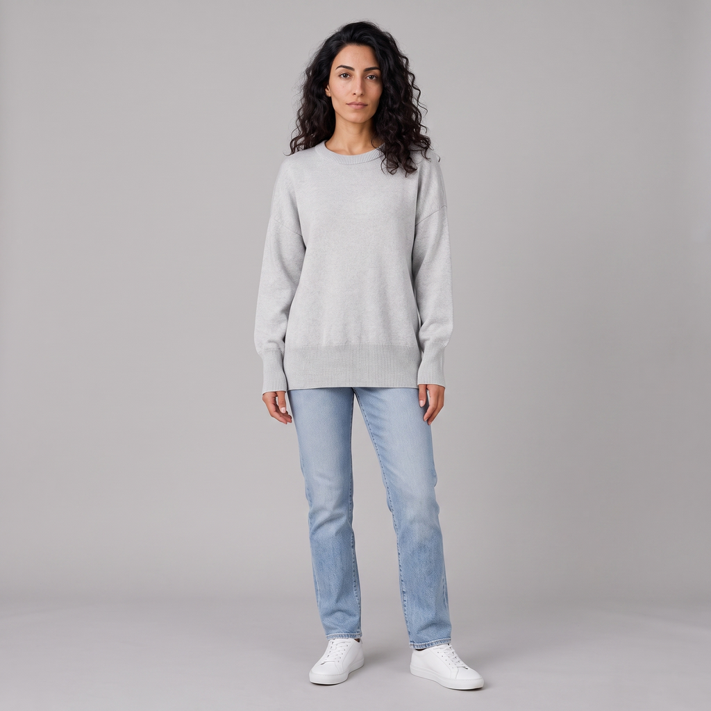 Model wearing the grey oversized knitted crew neck jumper, studio shot