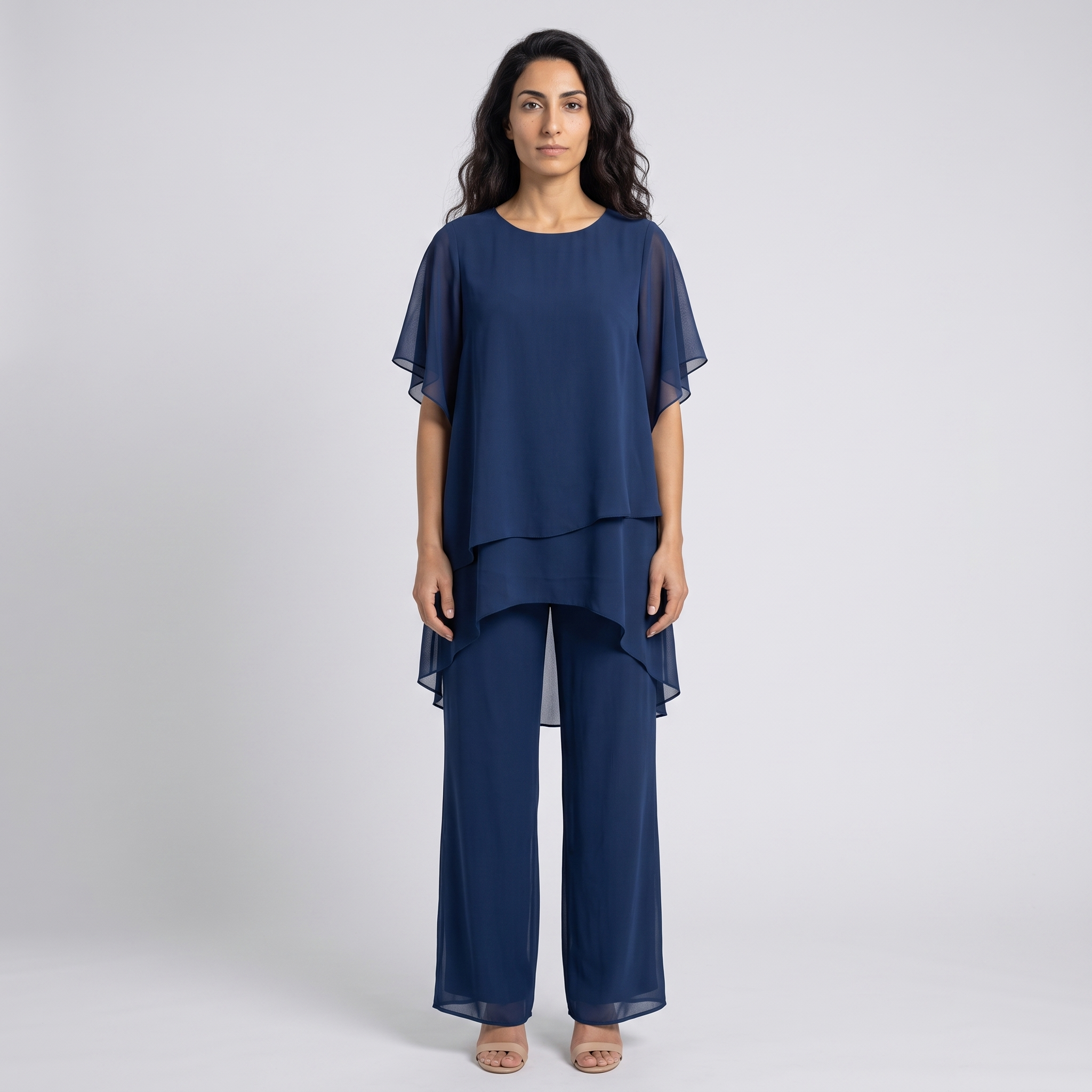 Model wearing the navy chiffon layered tunic and wide leg trousers set, studio shot