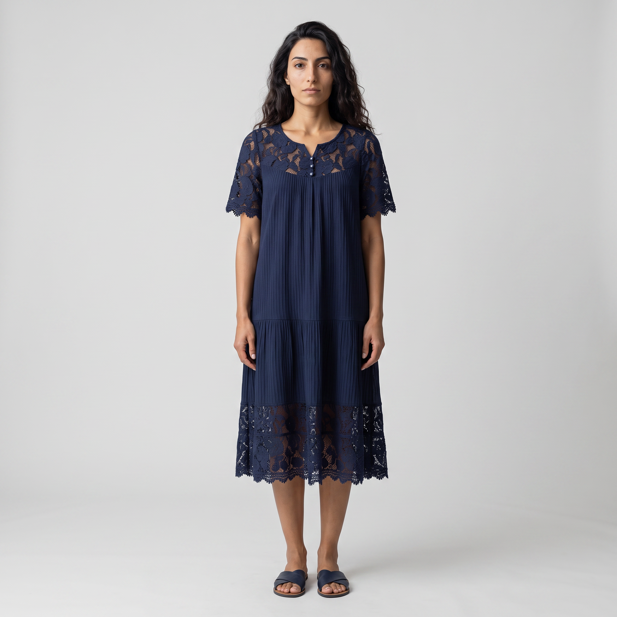 Model wearing the navy lace trim tiered midi dress, full length studio shot