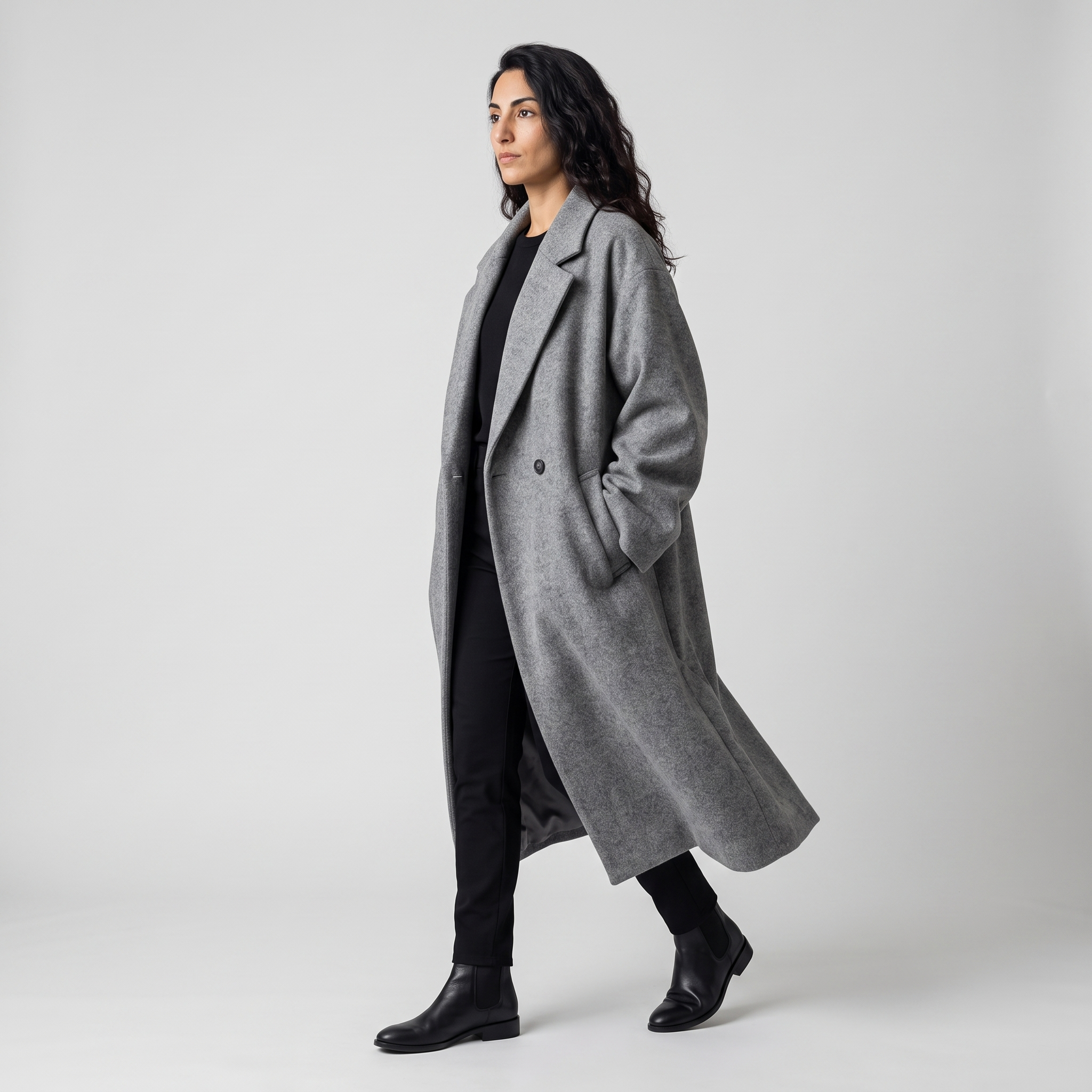 Side view of the grey oversized longline coat showing the drape and length
