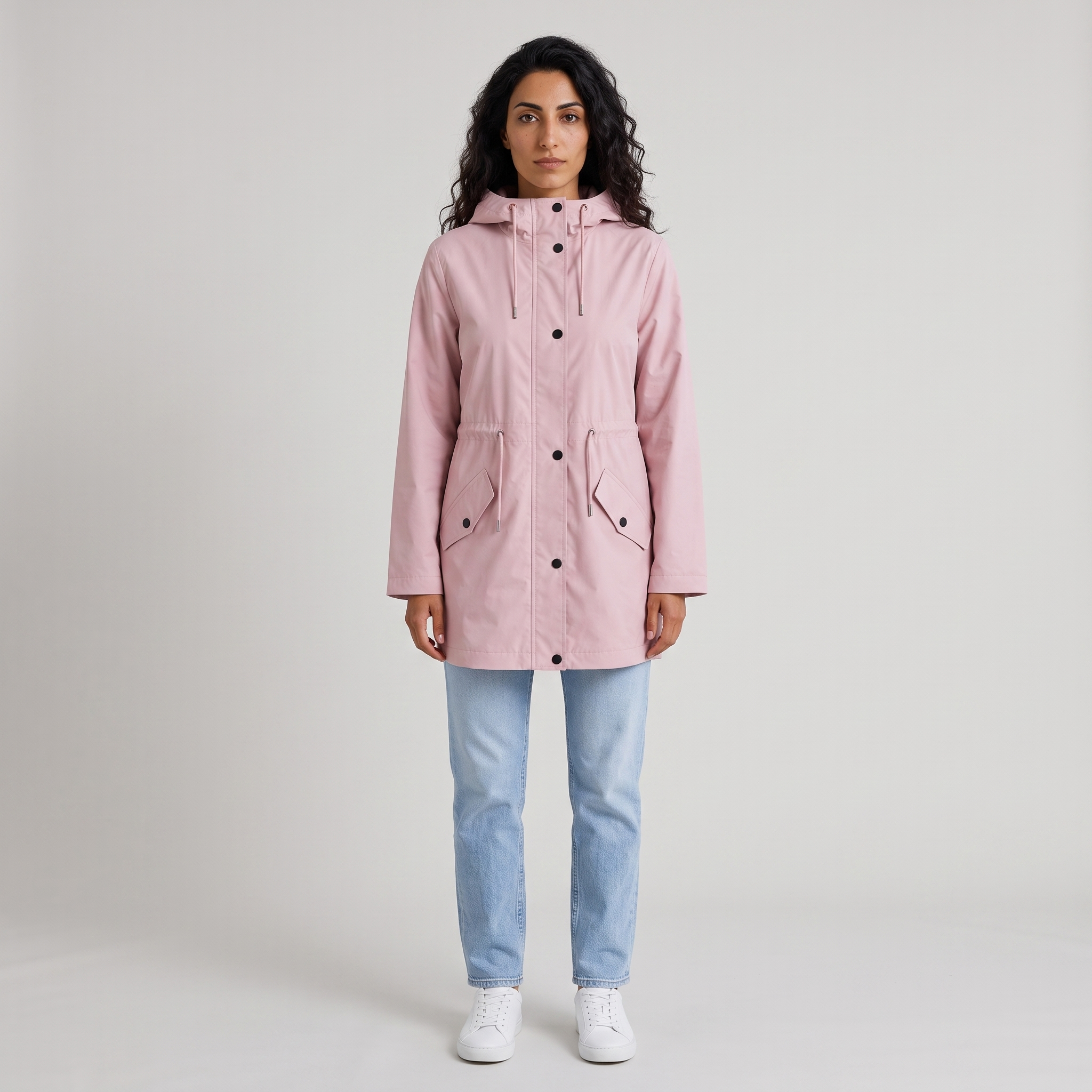 Model wearing the pink hooded waterproof parka with drawstring waist, studio shot